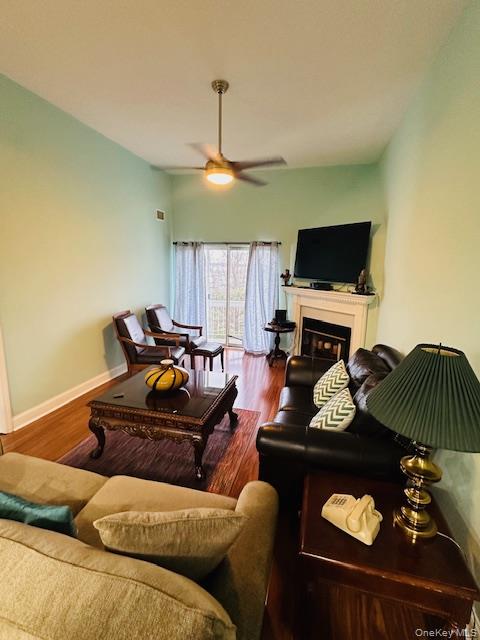 190 Schofield Street, Unit 2E Bronx, NY 10464 - Photo 16 of 24 a living room with furniture a fireplace and a flat screen tv