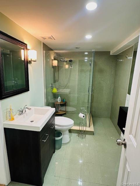 190 Schofield Street, Unit 2E Bronx, NY 10464 - Photo 20 of 24 a bathroom with a double vanity sink toilet and shower
