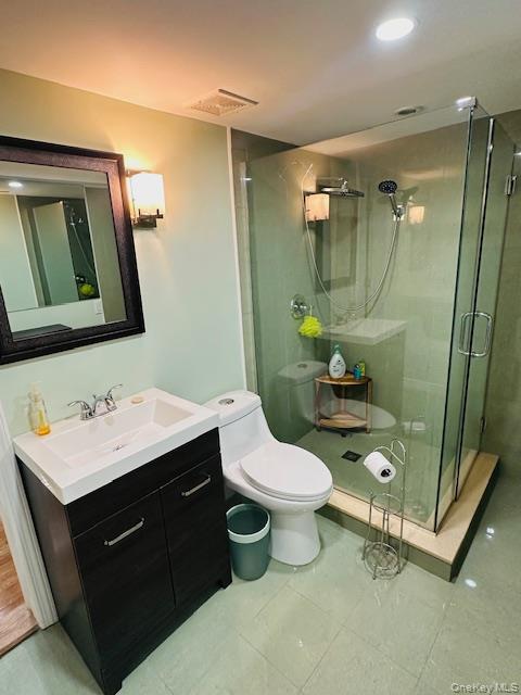 190 Schofield Street, Unit 2E Bronx, NY 10464 - Photo 21 of 24 a bathroom with a sink vanity mirror and toilet