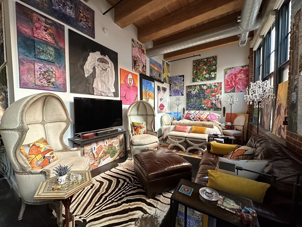 a living room with lots of furniture and a flat screen tv