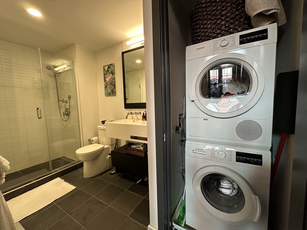319 A Street, Unit 305 Boston, MA 02210 - Photo 8 of 11 a view of a bathroom with washing machine and a sink