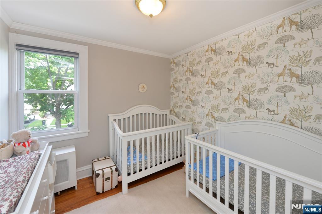 570 Shelton Road Ridgewood, NJ 07450 - Photo 17 of 26 a view of a bedroom with wooden floor and a window