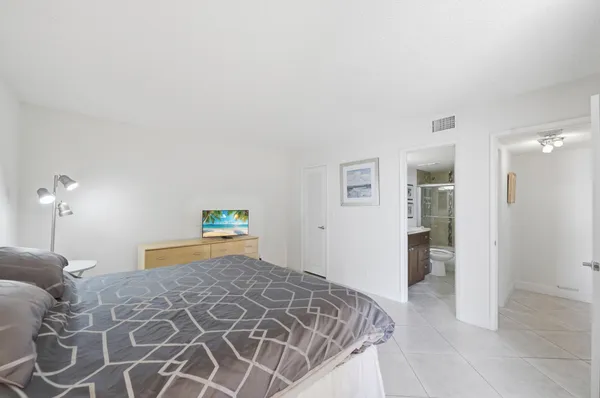 a bedroom with a bed and a lamp