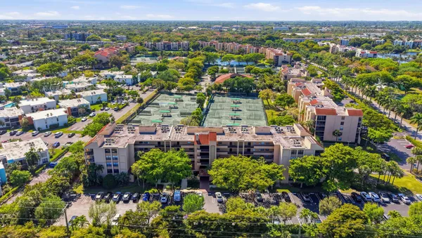 an aerial view of a city with lots of residential buildings and mountain view in back