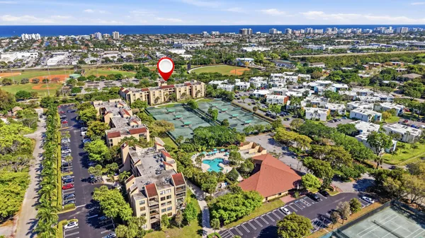 an aerial view of residential houses with outdoor space and swimming pool