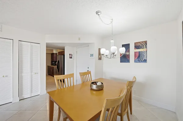 a view of a dining room with furniture and chandelier