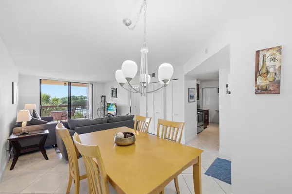 a view of a dining room with furniture and a chandelier
