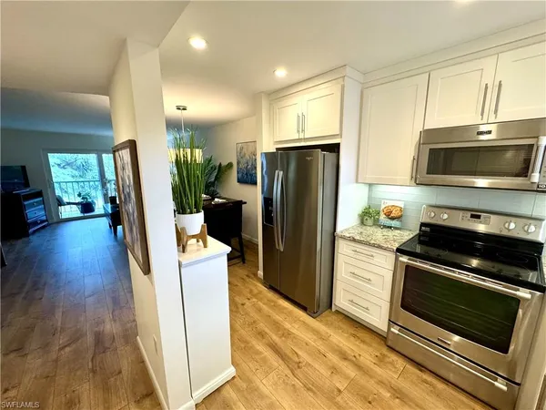 a kitchen with a refrigerator sink and microwave