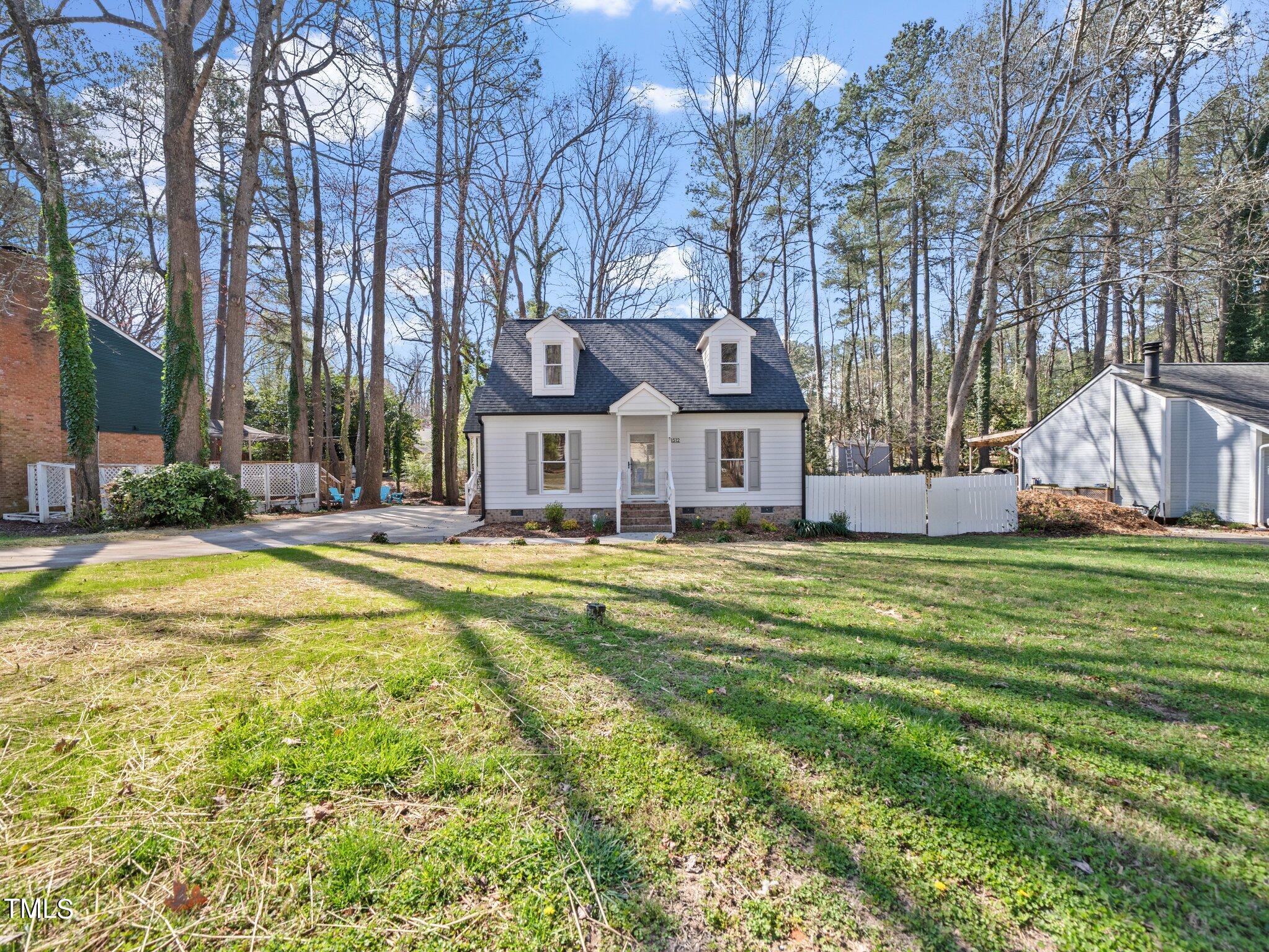 3512 Donna Road Raleigh, NC 27604 - Photo 3 of 28 a front view of a house with a yard table and chairs