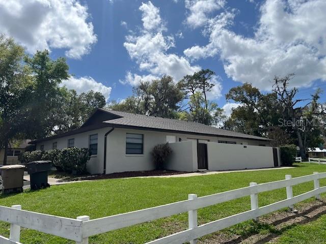 a view of an house with backyard space and garden