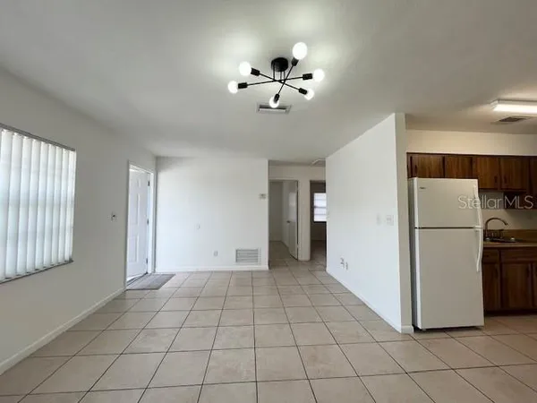 a kitchen with a refrigerator sink and cabinets