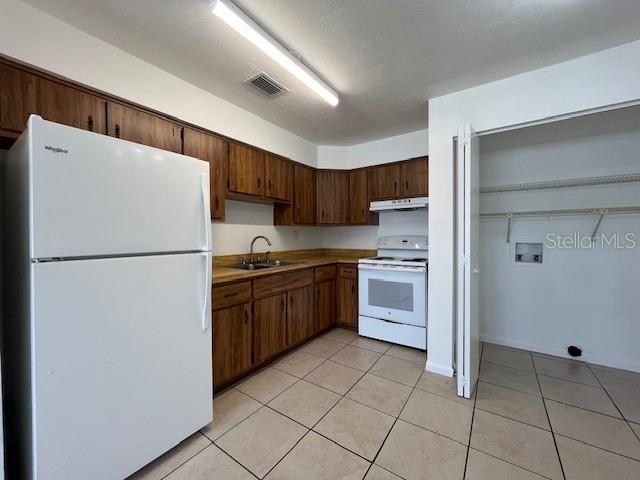 1902 Northeast 17th Place Ocala, FL 34470 - Photo 15 of 28 a kitchen with stainless steel appliances granite countertop a refrigerator sink a stove and a refrigerator