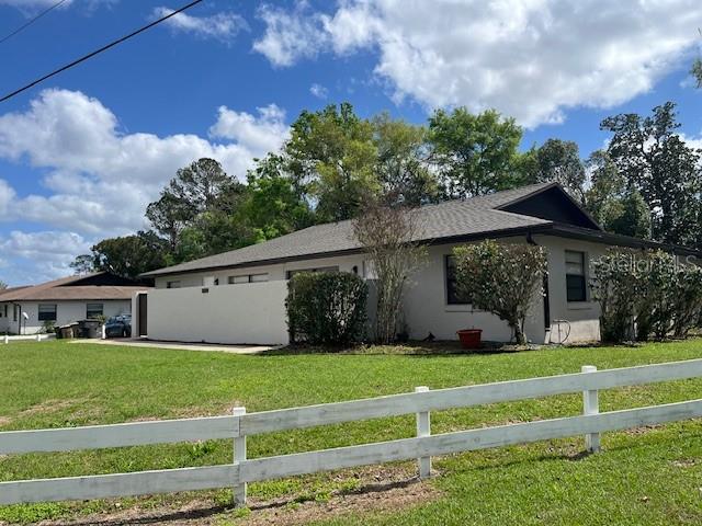 1902 Northeast 17th Place Ocala, FL 34470 - Photo 3 of 28 a view of a house with a big yard and potted plants