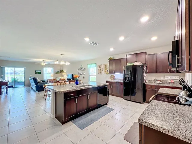 a kitchen with stainless steel appliances a sink stove and cabinets