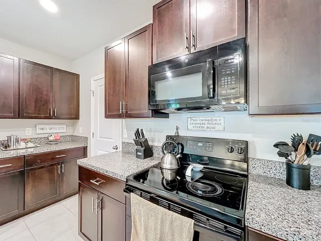 a kitchen with a sink a counter and chairs