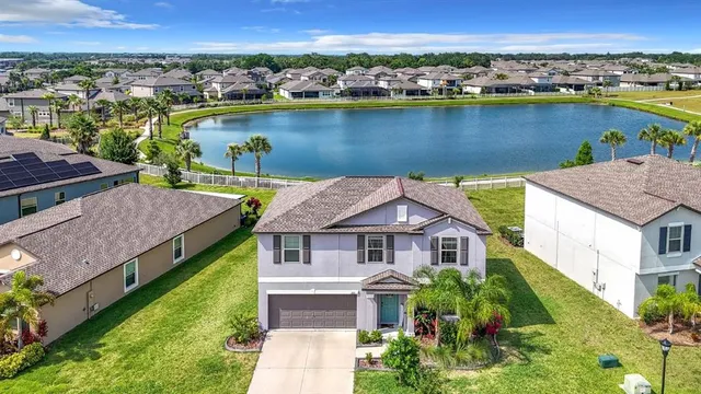 an aerial view of a house with a lake view