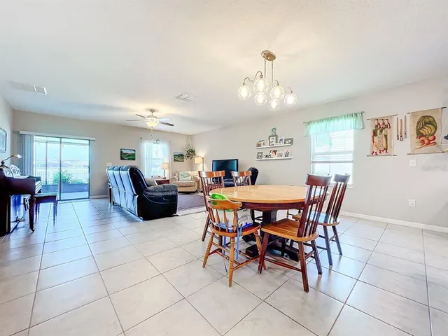 a view of a dining room with furniture and a kitchen