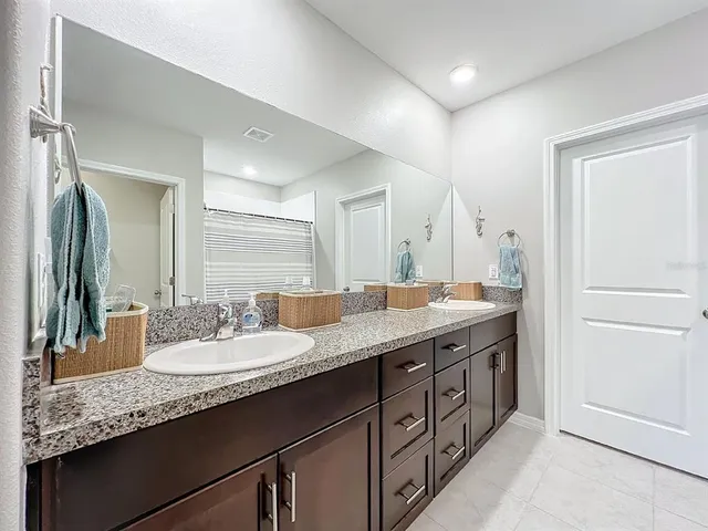a bedroom with furniture and a large window