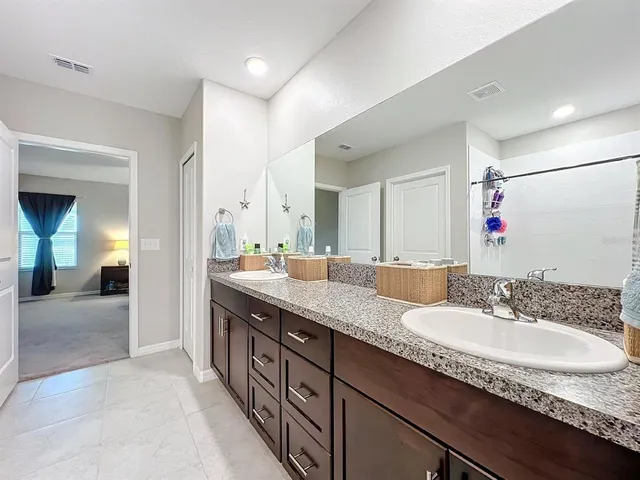 a bedroom with a bed and a ceiling fan