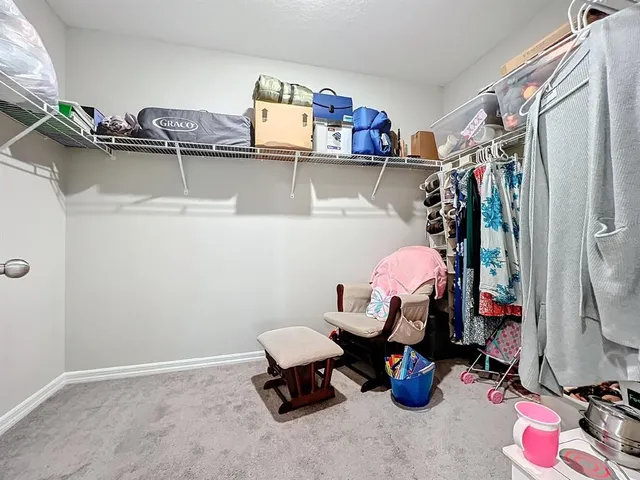 a spacious bedroom with a bed and a window