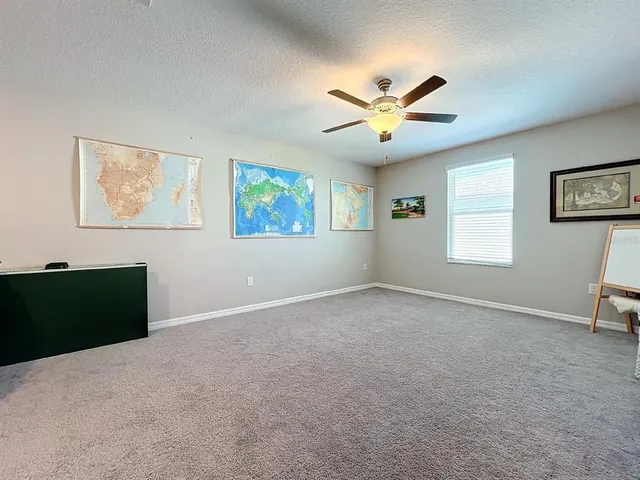 a bedroom with a bed and a ceiling fan
