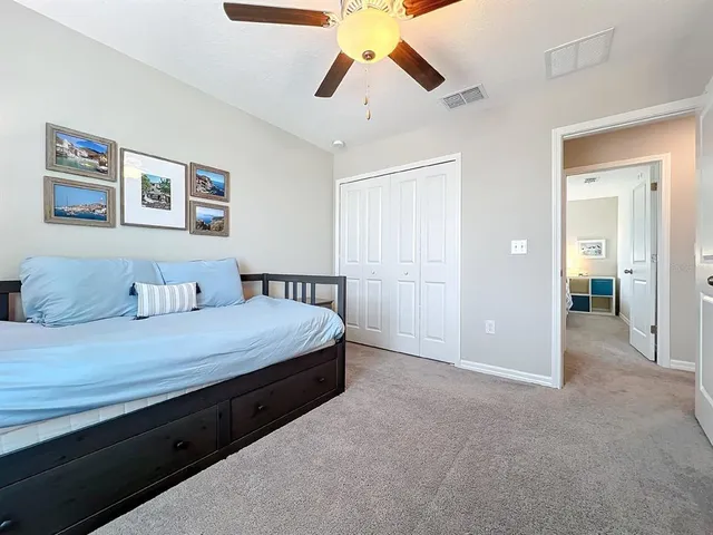 a view of a house with a big yard and large trees