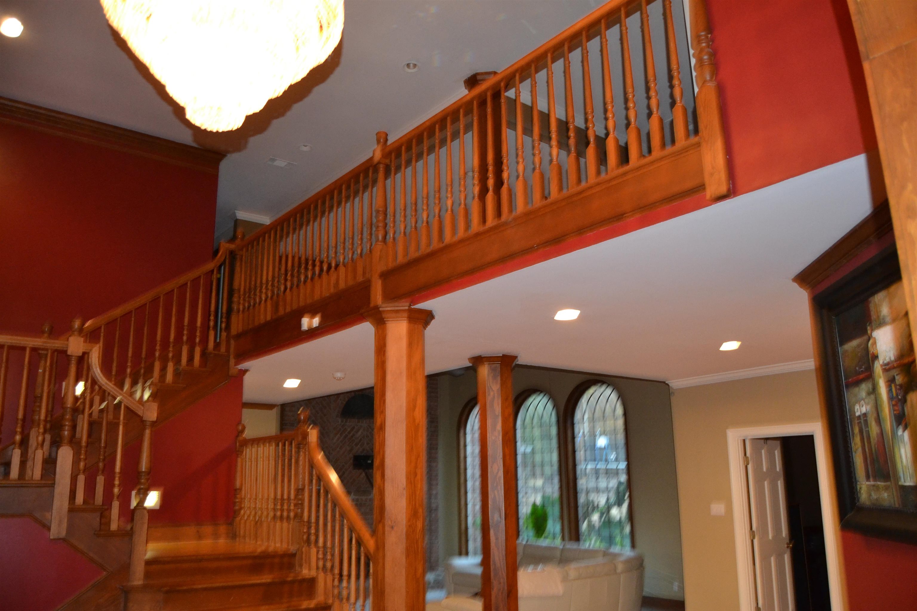 Stairway with ornamental molding and recessed lighting