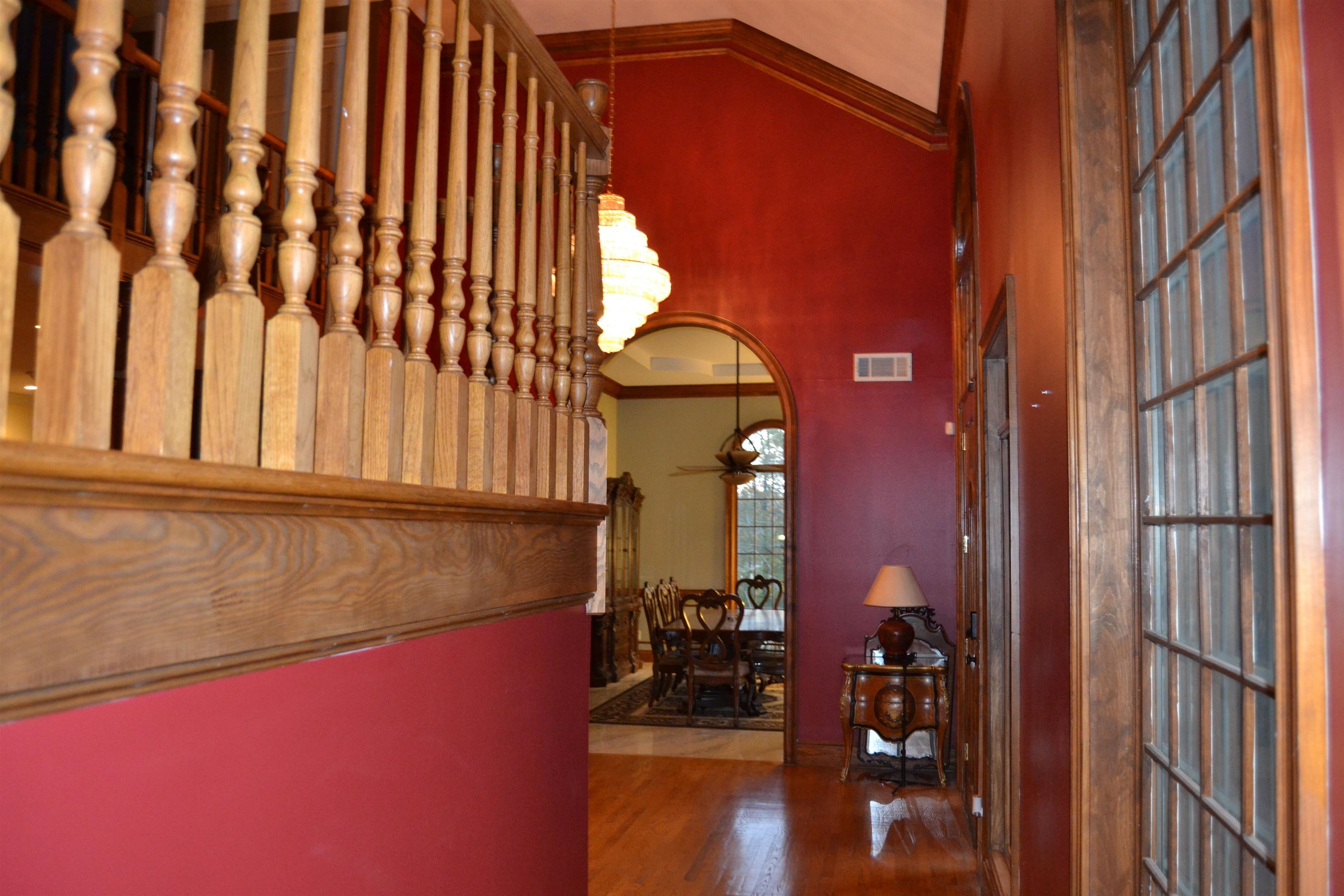 470 Walnut Point Cove Memphis, TN 38018 - Photo 2 of 37 Corridor featuring ornamental molding, wood finished floors, a chandelier, and arched walkways