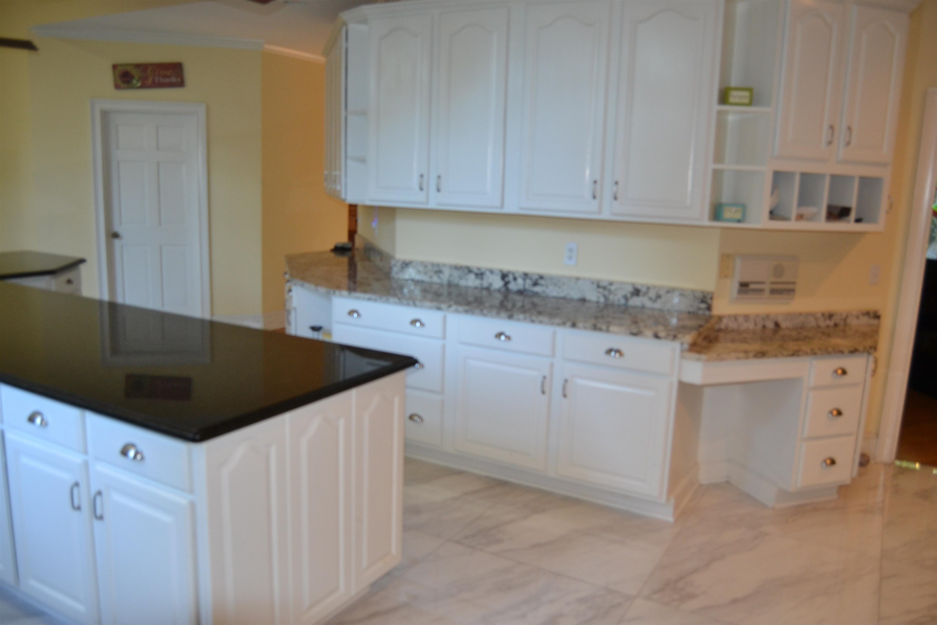 470 Walnut Point Cove Memphis, TN 38018 - Photo 30 of 37 Kitchen featuring white cabinetry, a kitchen island, light marble finish floors, and open shelves