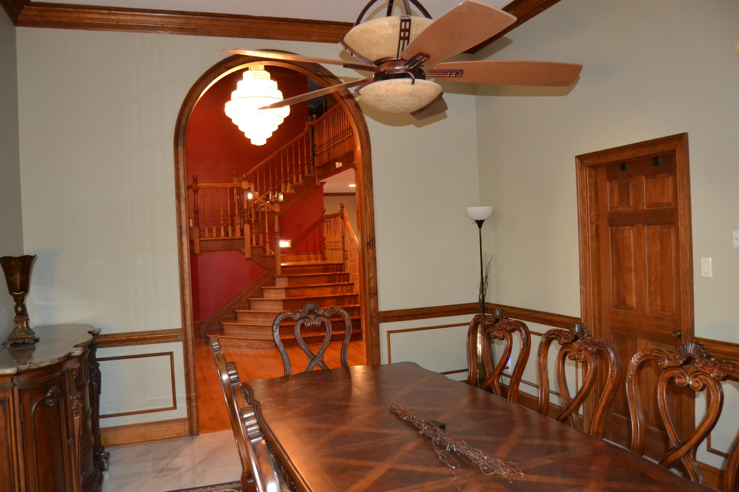 470 Walnut Point Cove Memphis, TN 38018 - Photo 3 of 37 Dining area with a wainscoted wall, stairs, arched walkways, ceiling fan, and a decorative wall