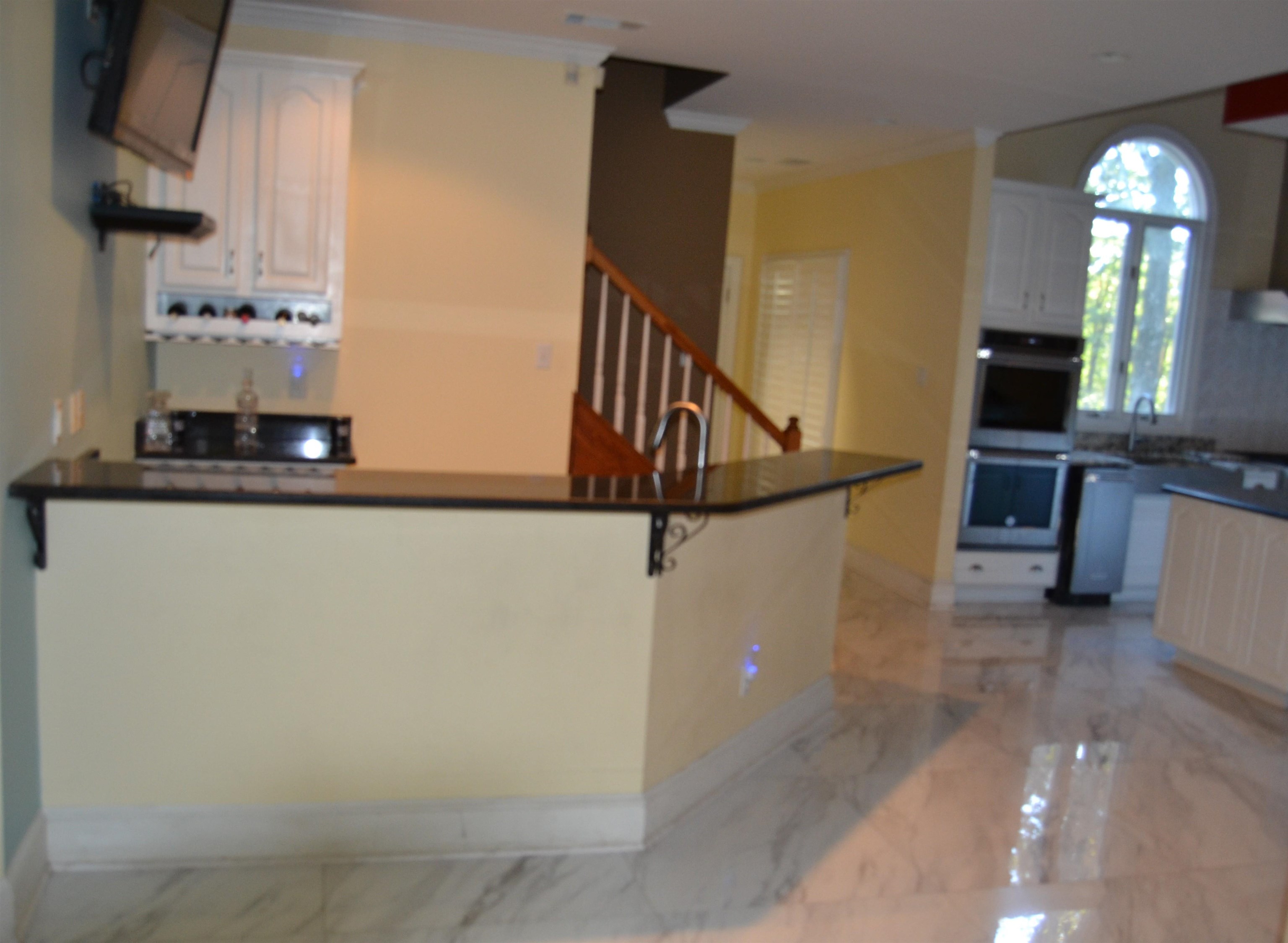 470 Walnut Point Cove Memphis, TN 38018 - Photo 31 of 37 Kitchen with dark countertops, light marble finish floors, open shelves, double oven, and ornamental molding