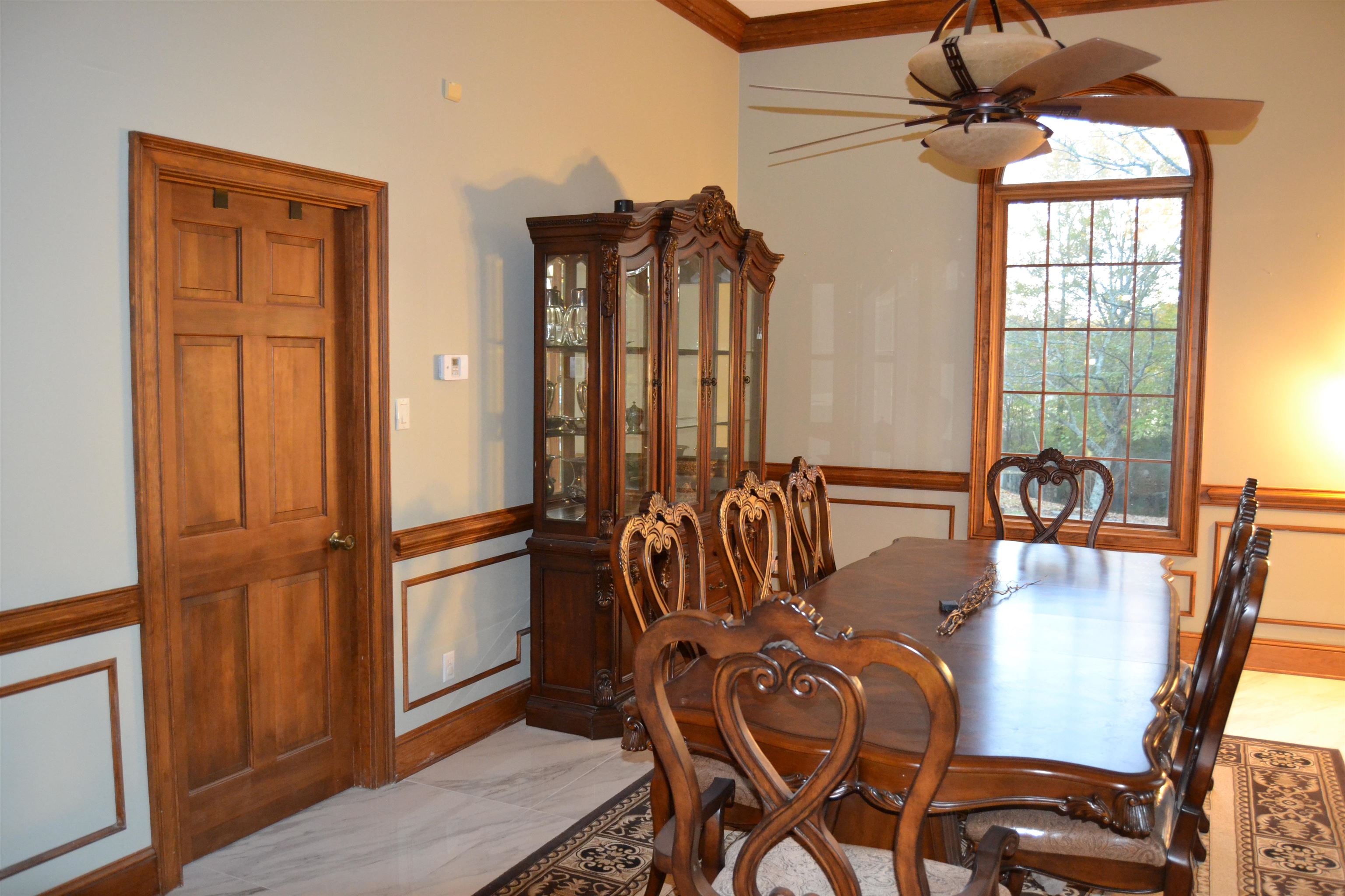 470 Walnut Point Cove Memphis, TN 38018 - Photo 5 of 37 Dining space featuring light marble finish flooring, wainscoting, ceiling fan, and crown molding