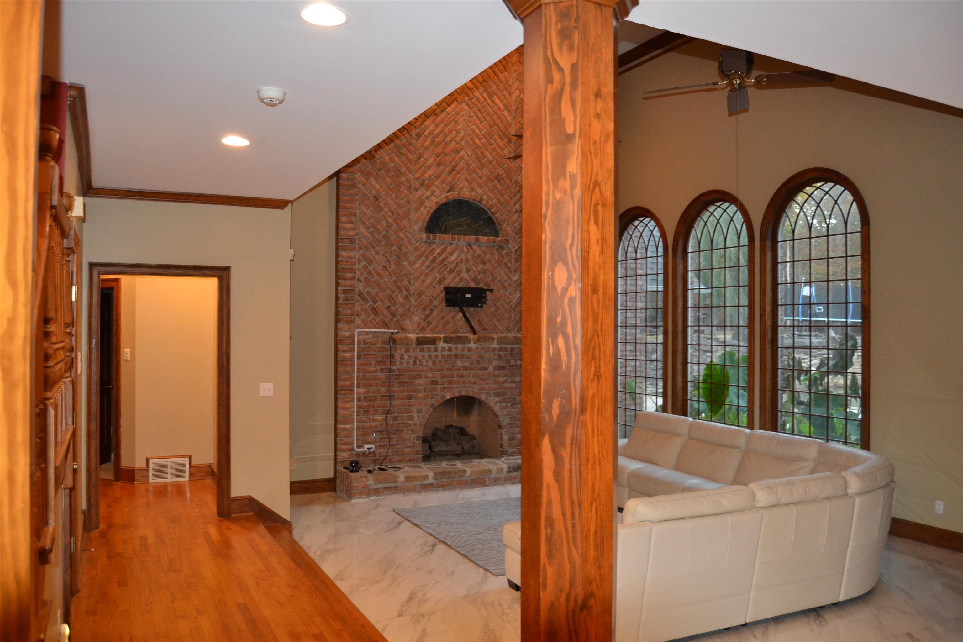 470 Walnut Point Cove Memphis, TN 38018 - Photo 6 of 37 Unfurnished living room with ornamental molding, a fireplace, wood finished floors, a ceiling fan, and recessed lighting