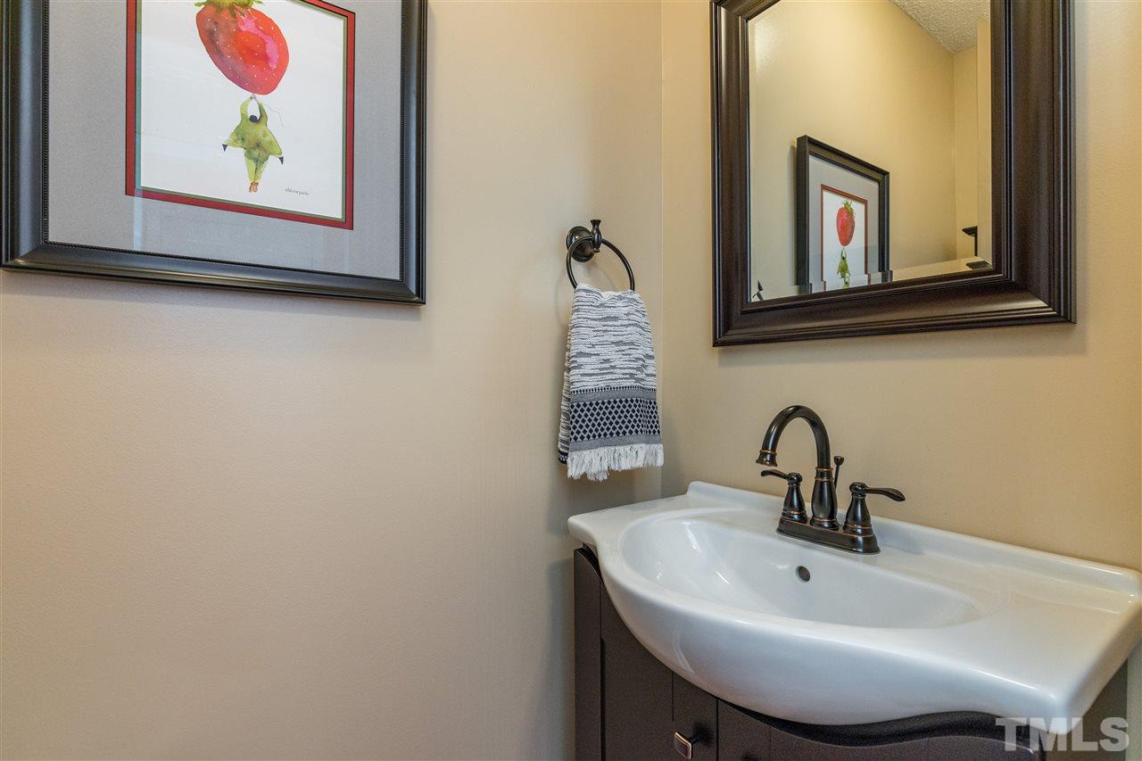 6004 Dedmon Place Raleigh, NC 27616 - Photo 13 of 30 a bathroom with a sink and a mirror