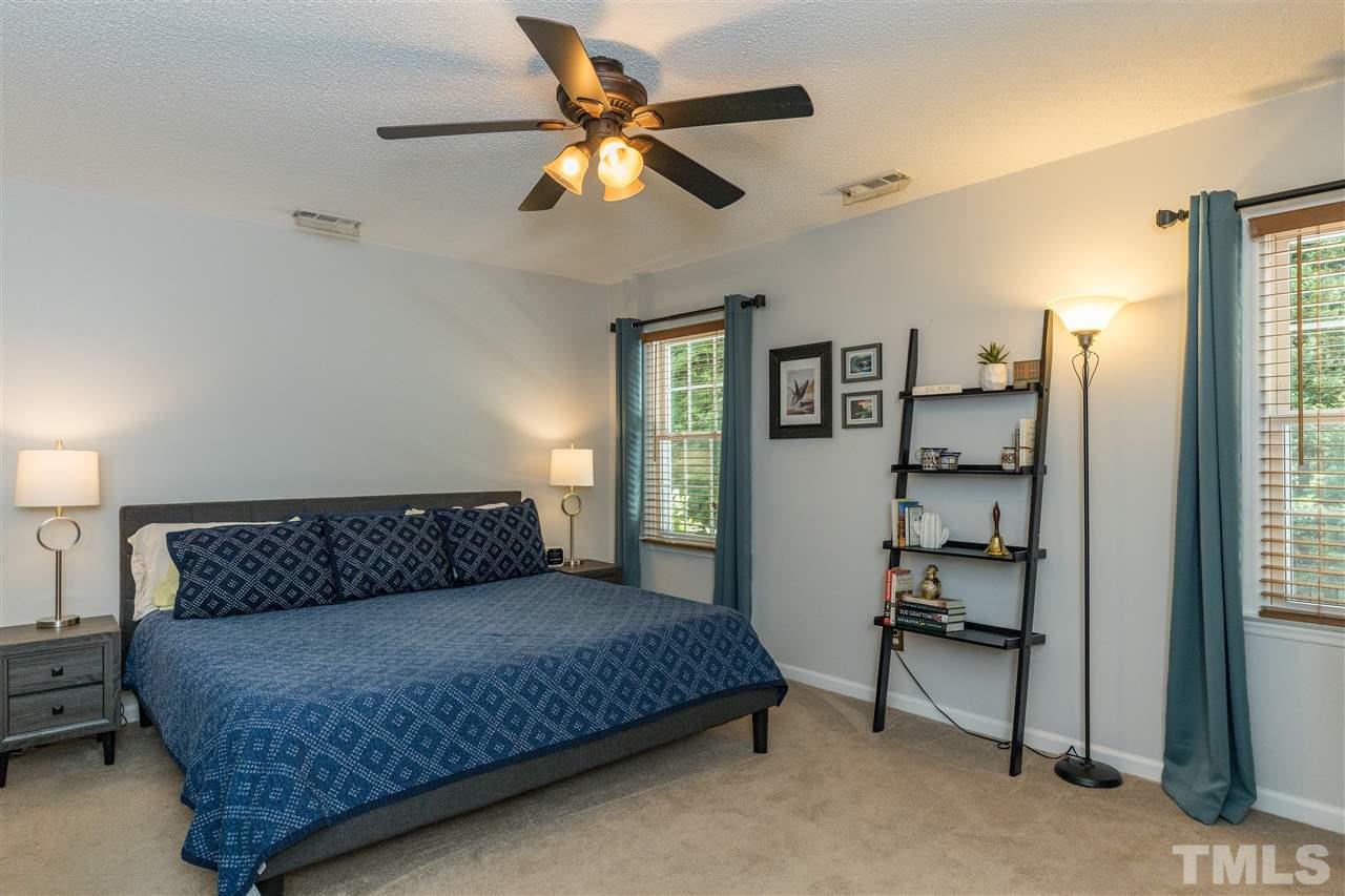 6004 Dedmon Place Raleigh, NC 27616 - Photo 14 of 30 a bedroom with a bed a window and a potted plant