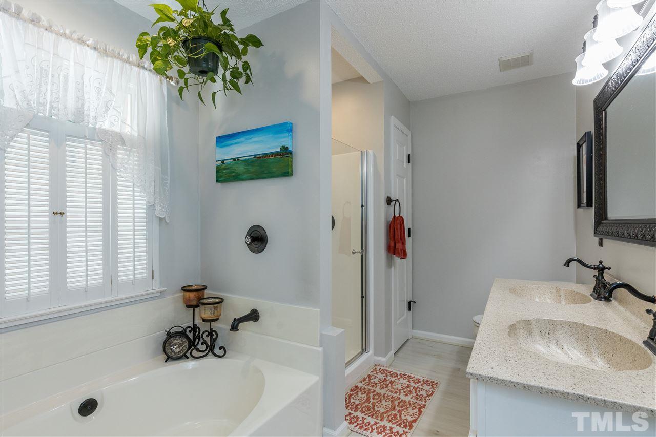 6004 Dedmon Place Raleigh, NC 27616 - Photo 17 of 30 a bathroom with a sink and a bathtub