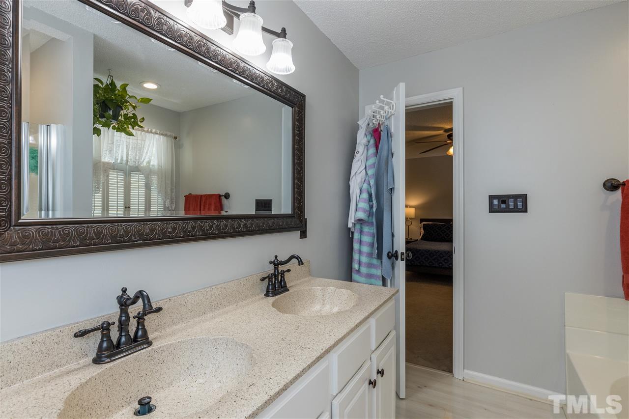 6004 Dedmon Place Raleigh, NC 27616 - Photo 18 of 30 a bathroom with a sink and a mirror