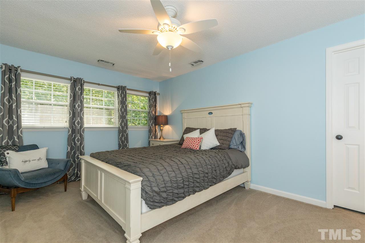 6004 Dedmon Place Raleigh, NC 27616 - Photo 20 of 30 a bedroom with a bed and a chandelier