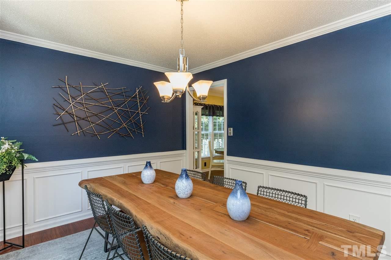 6004 Dedmon Place Raleigh, NC 27616 - Photo 4 of 30 a kitchen with a sink a table and chairs