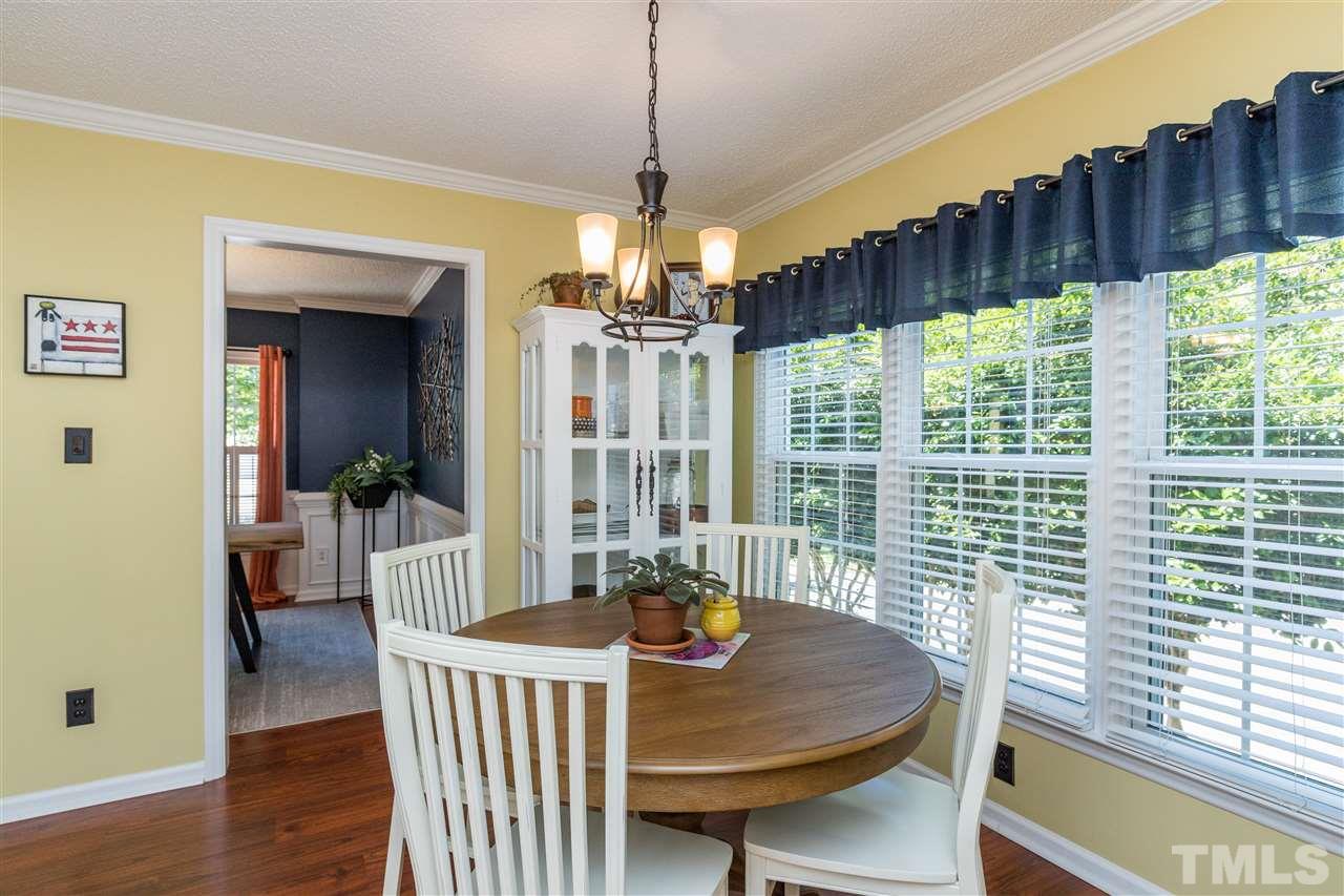 6004 Dedmon Place Raleigh, NC 27616 - Photo 7 of 30 a view of a dining room with furniture window and wooden floor