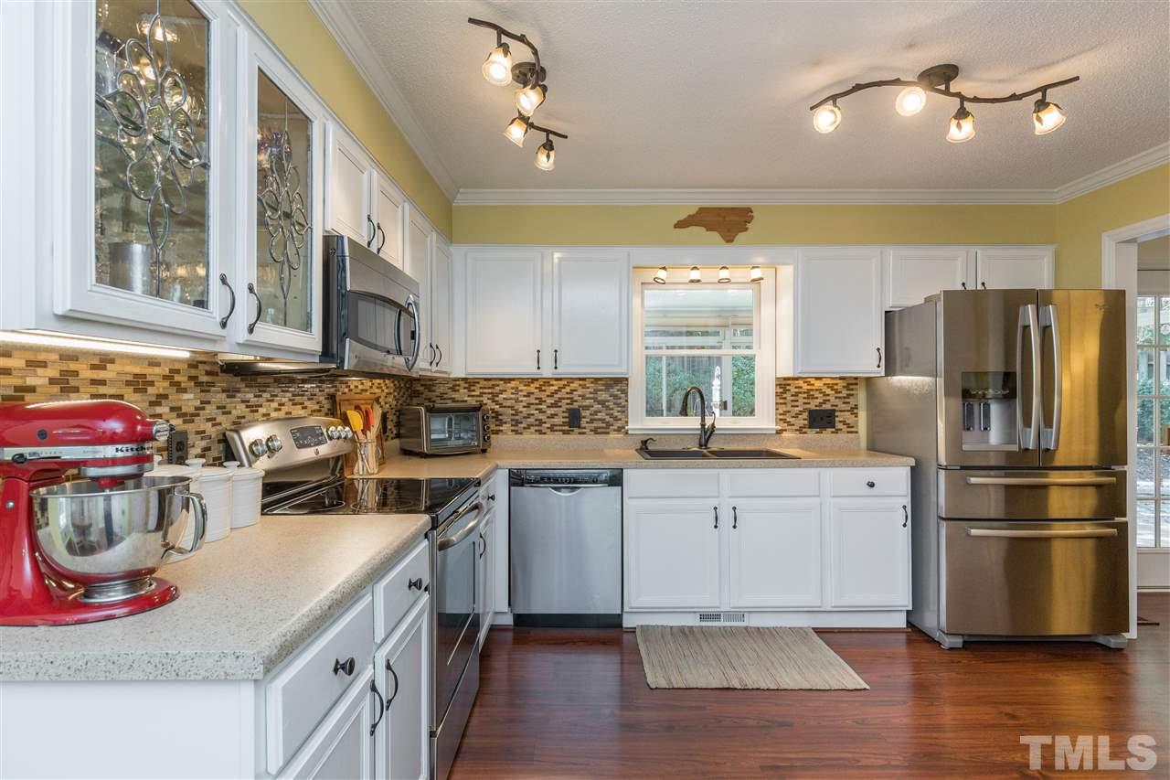 6004 Dedmon Place Raleigh, NC 27616 - Photo 8 of 30 a kitchen with a sink stove and refrigerator