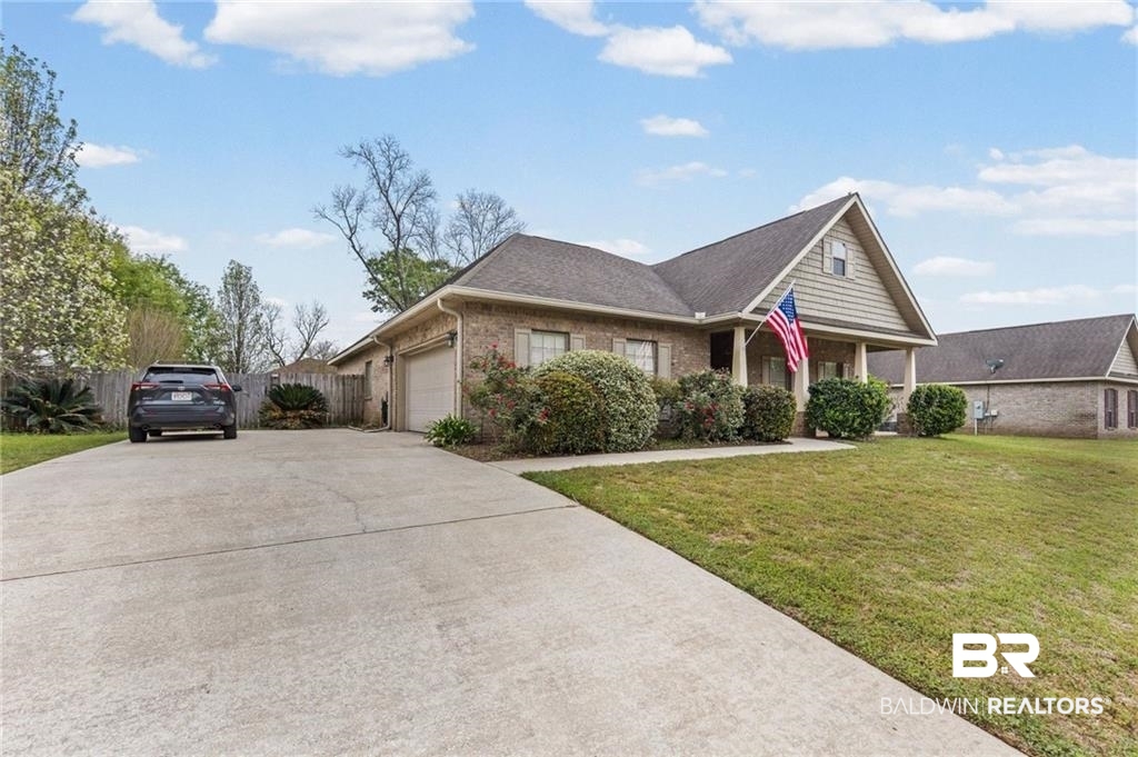 2570 Pecan Pointe Drive Semmes, AL 36575 - Photo 20 of 22 View of front of home featuring an attached garage, brick siding, driveway, and roof with shingles