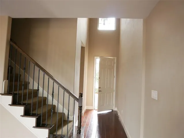a view of entryway with wooden floor and stairs