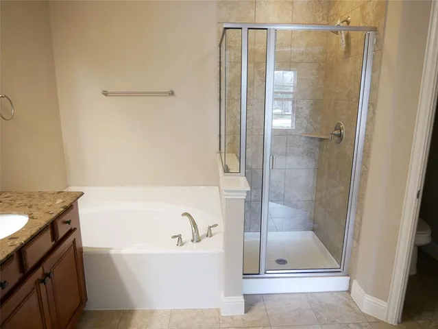 a bathroom with a bathtub and a shower