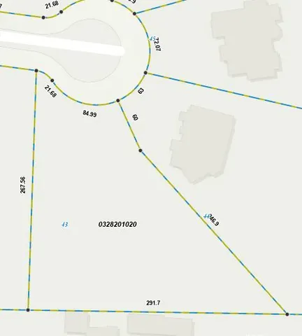 a picture of a room with a door and a white refrigerator