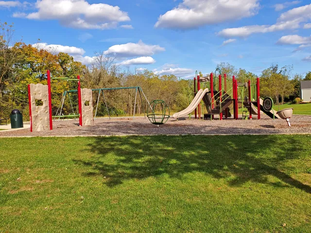 a view of a park with swings and slides