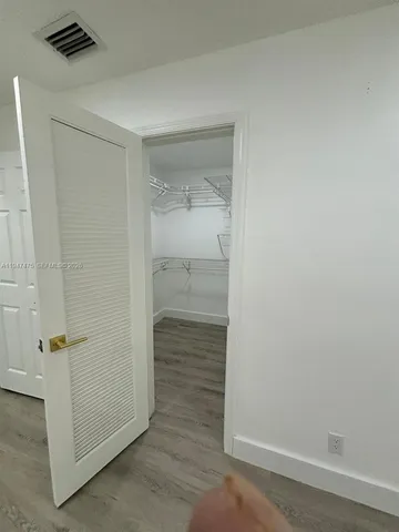 a bathroom with a sink a toilet a mirror and shower