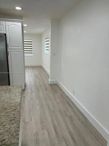 a view of room with window and hardwood floor