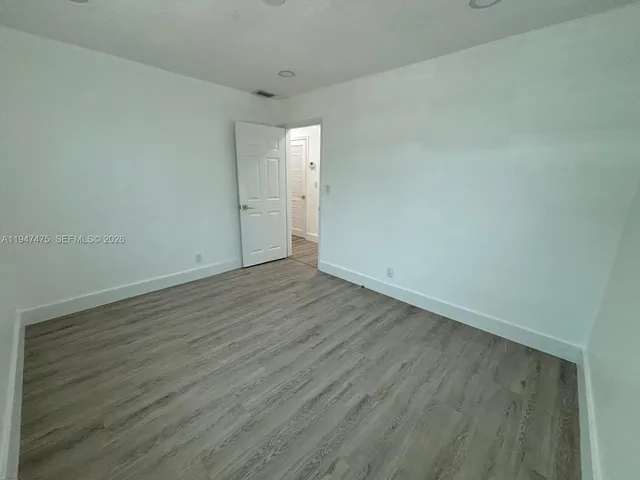 a spacious bathroom with a sink a mirror and toilet