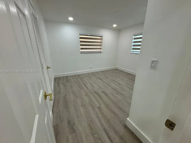 a bathroom with a sink a toilet a mirror and window